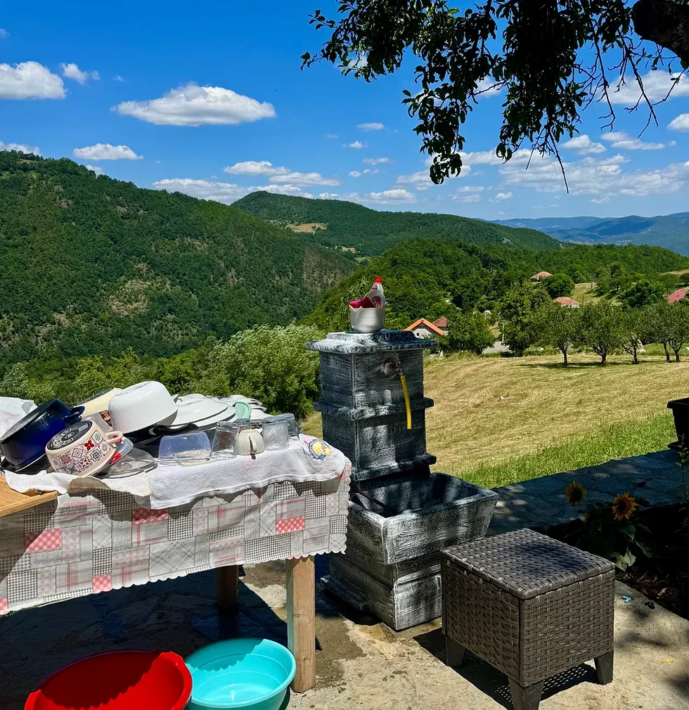 Washing dishes outside in the mountains